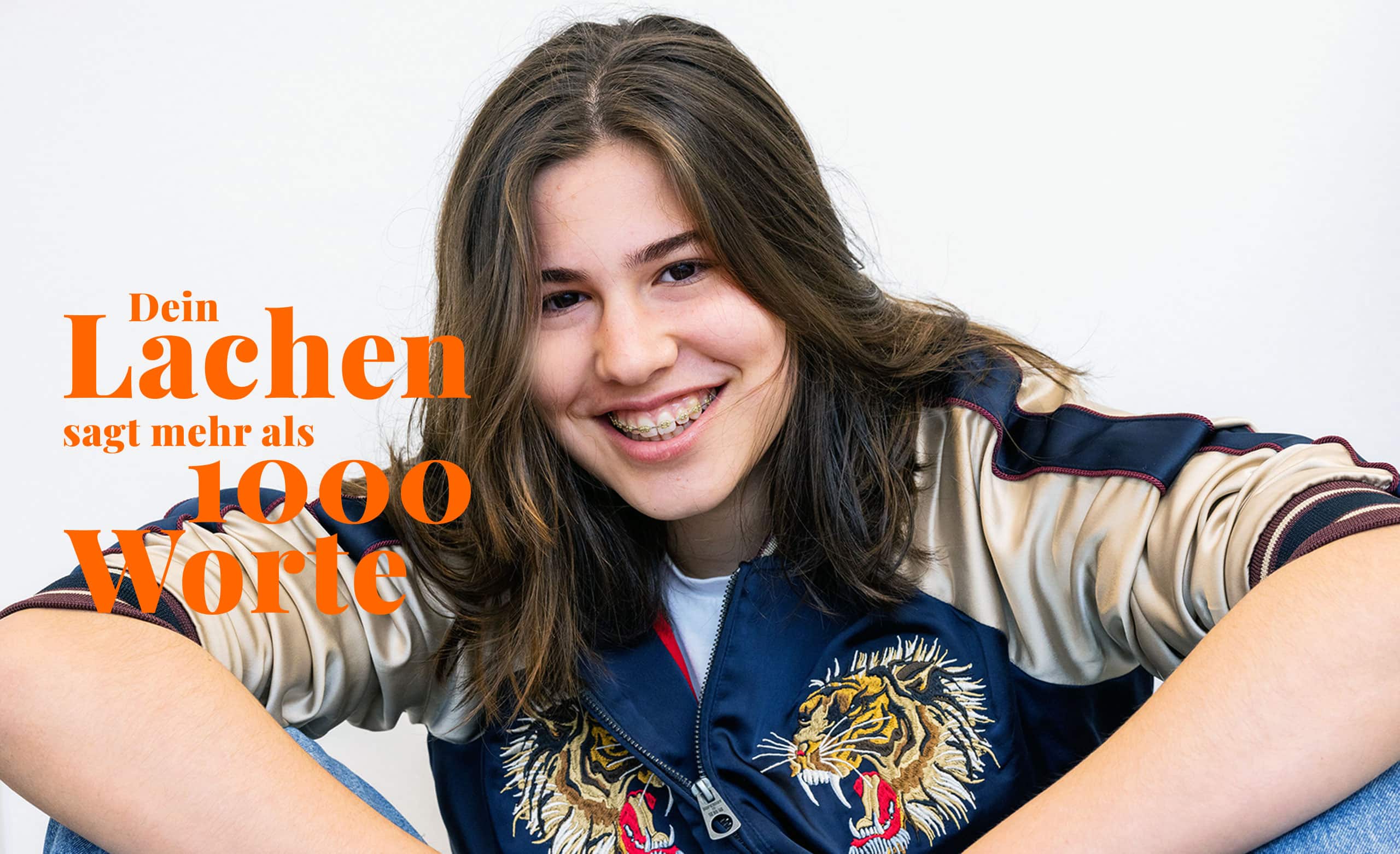 Werbeplakat mit dem Slogan "Dein Lachen sagt mehr als 1000 Worte"